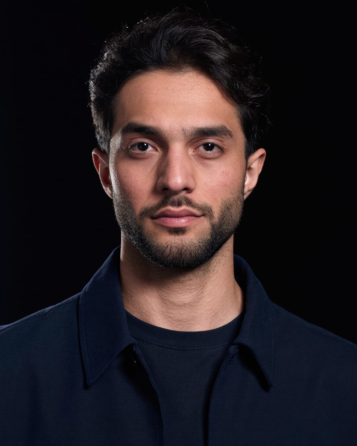 Ali Al-Khafaji standing at the studio worktable