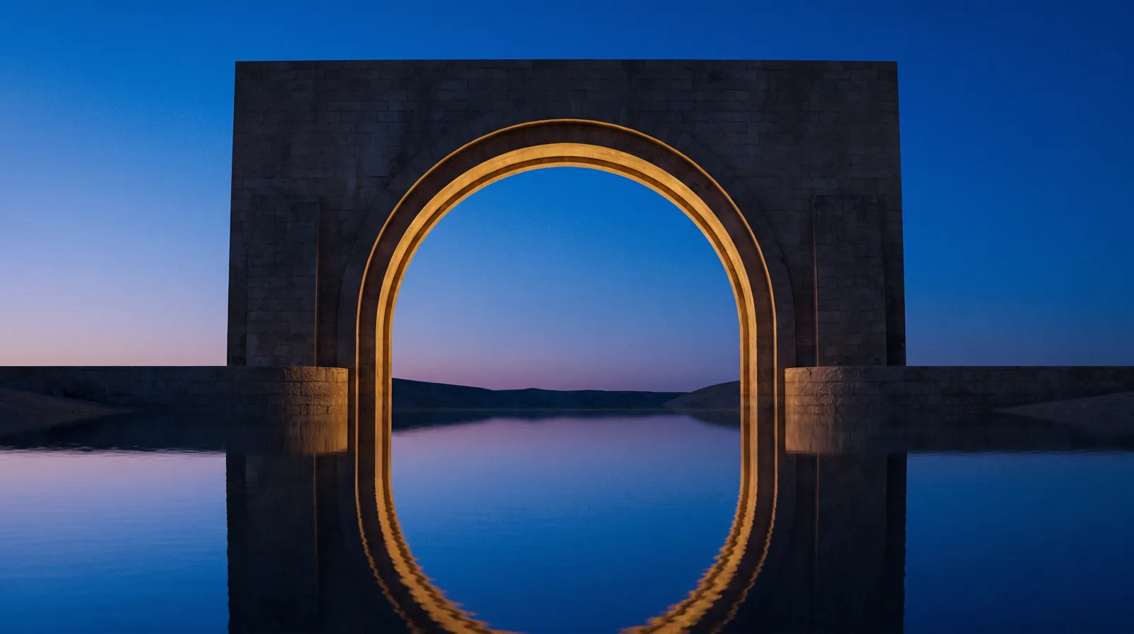 A monumental circular gate above dark blue water